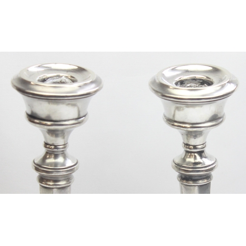 1018 - A pair of silver candlesticks of hexagonal form, marked for Birmingham 1958 by Sanders & Mackenzie (... 