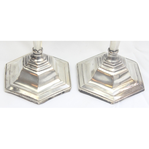 1018 - A pair of silver candlesticks of hexagonal form, marked for Birmingham 1958 by Sanders & Mackenzie (... 