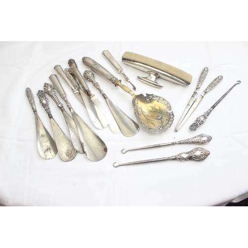 1032 - A large qty of assorted silver handled items to inc button hooks, shoe horns, glove stretchers etc, ... 