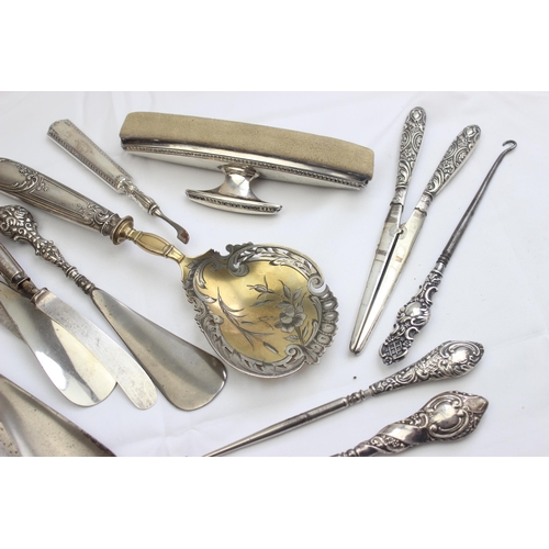 1032 - A large qty of assorted silver handled items to inc button hooks, shoe horns, glove stretchers etc, ... 