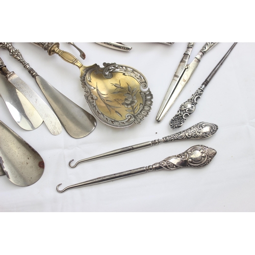 1032 - A large qty of assorted silver handled items to inc button hooks, shoe horns, glove stretchers etc, ... 