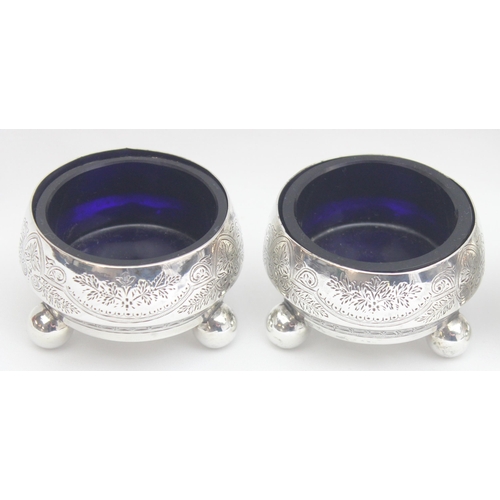 1076 - A set of 3 Victorian silver salts with blue glass liners, the bodies with engraved decoration and 3 ... 