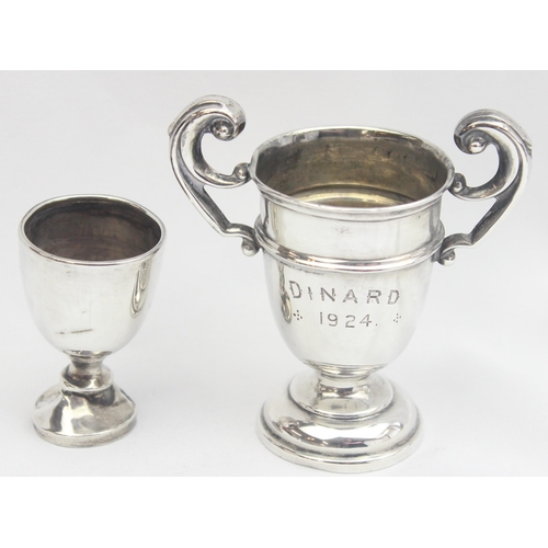 1078 - 2 miniature early 20th century silver trophies, the largest approx 75mm tall, approx 29.97g gross