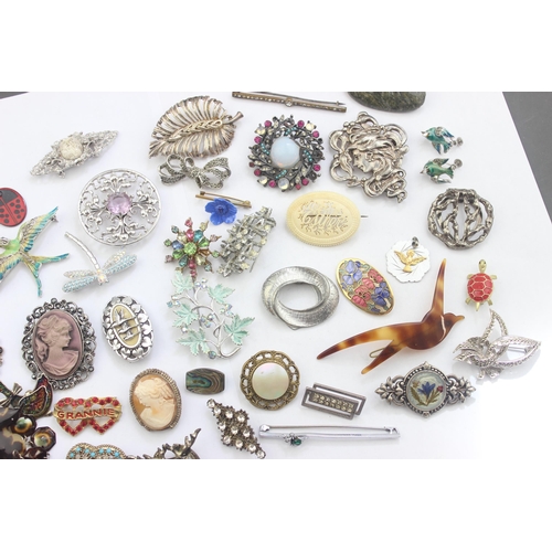 1153 - A large qty of assorted of assorted costume jewellery pendants and brooches etc