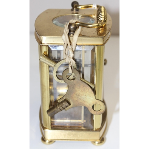 1317 - A vintage Rapport of London brass cased carriage clock with bevelled glass panels, approx 11cm tall ... 