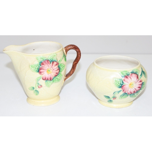 1697 - A flora motif tea set, Australian design by Carltonware to include a teapot, milk jug and sugar bowl