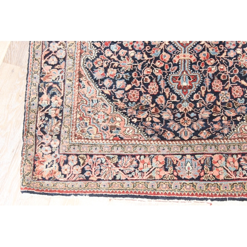 212 - A vintage Heriz style rug of blue ground with decorative motifs, approx 155cm x 114cm