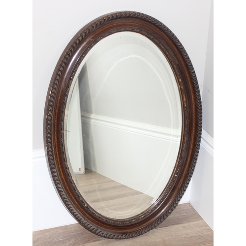 450Z - Large vintage carved oak oval wall mirror, approx 87 x 63cm