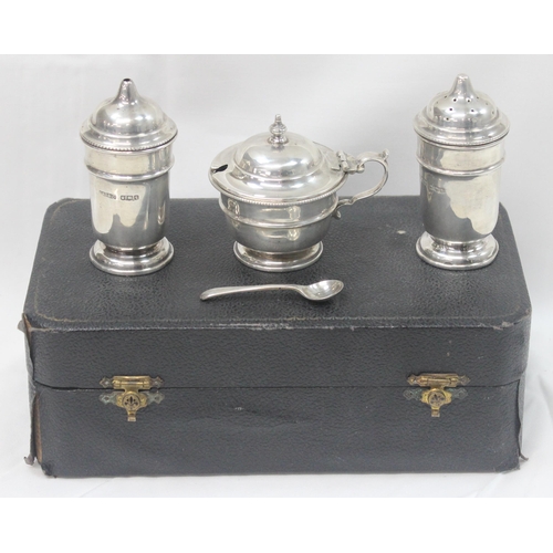 1065 - A boxed silver 3 piece cruet set, Sheffield 1933 by R McD & Co, matching silver mustard spoon by Wal... 