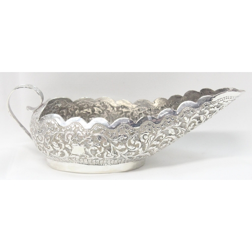 1071 - A highly decorative Anglo-Indian or Burmese silver sauce boat with embossed decoration, unmarked but... 