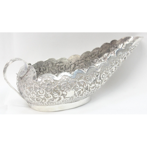 1071 - A highly decorative Anglo-Indian or Burmese silver sauce boat with embossed decoration, unmarked but... 