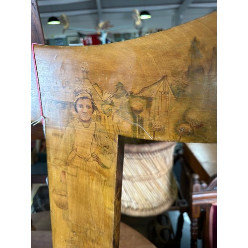 7 - A very unusual antique pokerwork spinning chair, the back decorated with a scene of a young girl wit... 