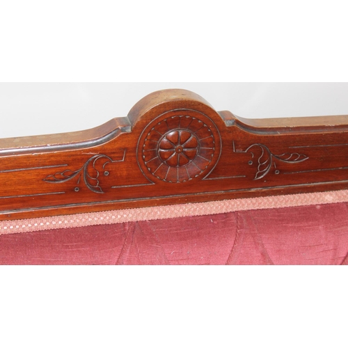 104 - Antique button back mahogany framed salon sofa with pink upholstery and carved details, approx 193 x... 