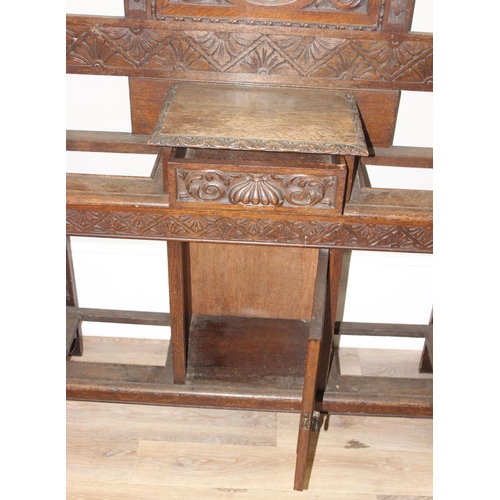 5 - Antique oak hall stand with heavily carved decoration and wrought iron coat hooks, with maker's mark... 