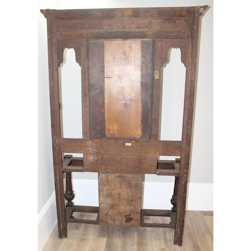 5 - Antique oak hall stand with heavily carved decoration and wrought iron coat hooks, with maker's mark... 