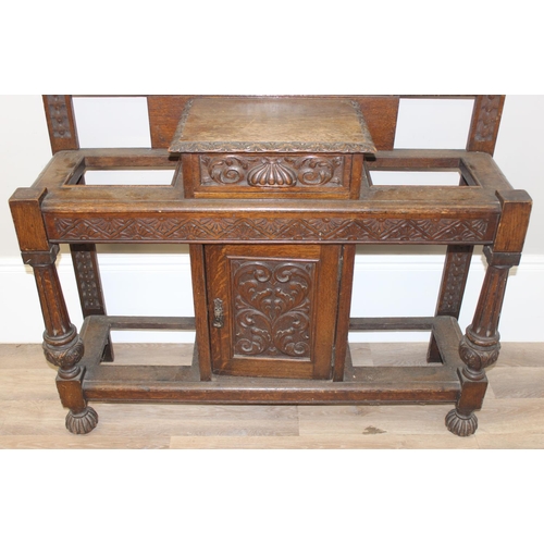 5 - Antique oak hall stand with heavily carved decoration and wrought iron coat hooks, with maker's mark... 