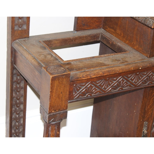 5 - Antique oak hall stand with heavily carved decoration and wrought iron coat hooks, with maker's mark... 