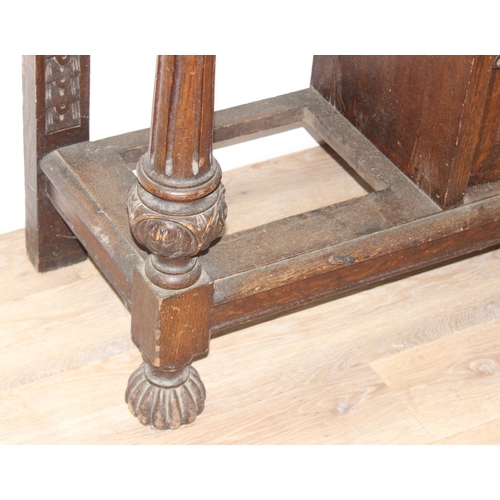 5 - Antique oak hall stand with heavily carved decoration and wrought iron coat hooks, with maker's mark... 