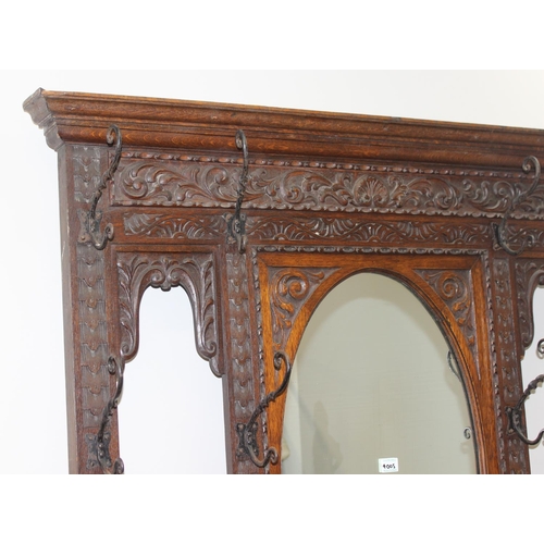 5 - Antique oak hall stand with heavily carved decoration and wrought iron coat hooks, with maker's mark... 