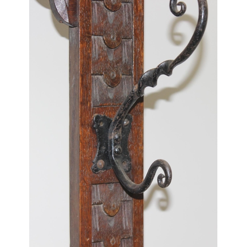 5 - Antique oak hall stand with heavily carved decoration and wrought iron coat hooks, with maker's mark... 