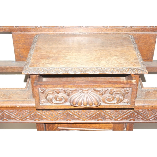 5 - Antique oak hall stand with heavily carved decoration and wrought iron coat hooks, with maker's mark... 