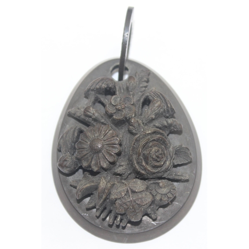 1157 - An unusual deep carved Victorian mourning jewellery pendant, carved in relief with flowers, believed... 