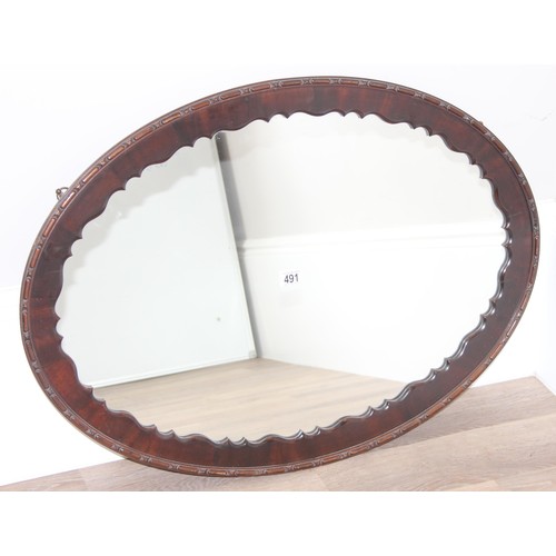 582 - Large vintage carved oak oval wall mirror, approx 87 x 63cm and a Large Edwardian mahogany framed wa... 