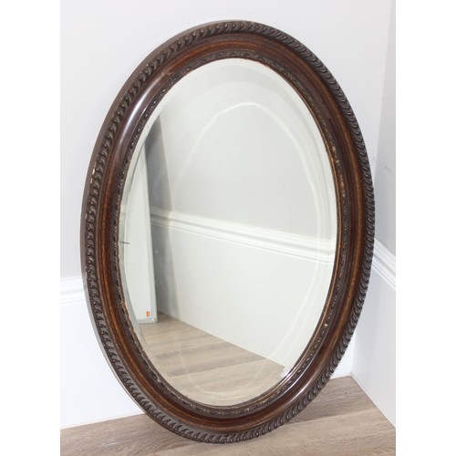 582 - Large vintage carved oak oval wall mirror, approx 87 x 63cm and a Large Edwardian mahogany framed wa... 