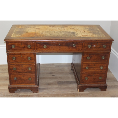 106 - An antique mahogany pedestal desk with 9 drawers and distressed leather top, approx 130cm wide x 69c... 