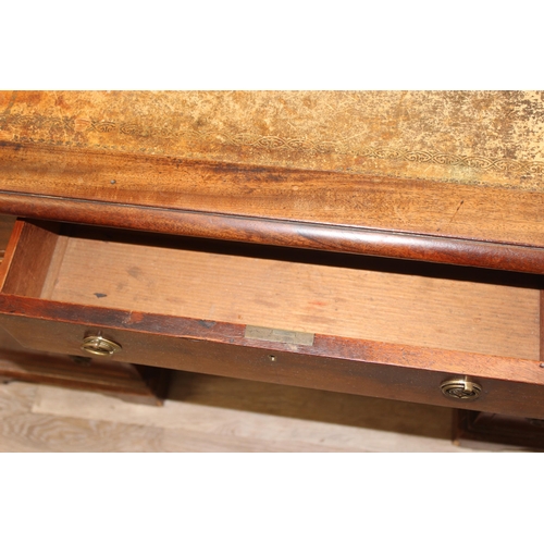 106 - An antique mahogany pedestal desk with 9 drawers and distressed leather top, approx 130cm wide x 69c... 