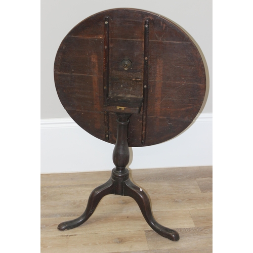 40 - A Georgian oak tilt-top table with tripod base, approx 74cm diameter x 68cm tall