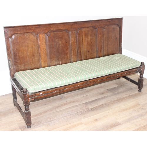 31 - A long antique oak high backed bench or settle with cushion seat, approx 182cm wide x 60cm deep x 10... 