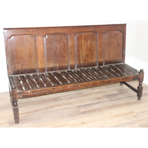 31 - A long antique oak high backed bench or settle with cushion seat, approx 182cm wide x 60cm deep x 10... 