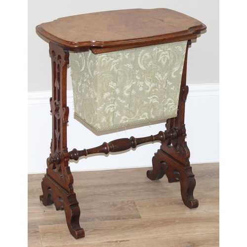 46 - A Victorian walnut sewing table with fabric bag and decorative supports, with contents, approx 59cm ... 