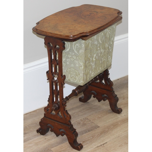 46 - A Victorian walnut sewing table with fabric bag and decorative supports, with contents, approx 59cm ... 