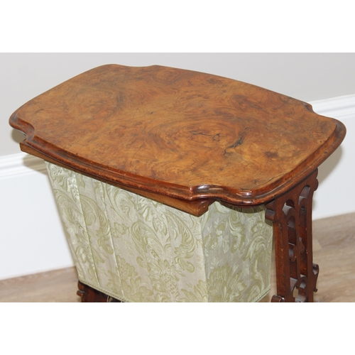 46 - A Victorian walnut sewing table with fabric bag and decorative supports, with contents, approx 59cm ... 