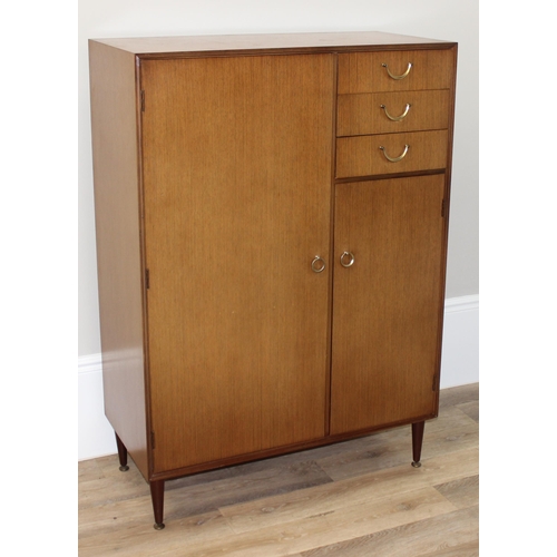 65 - A retro Meredew gentleman's wardrobe with 3 short drawers, one containing a fold out mirror, approx ... 