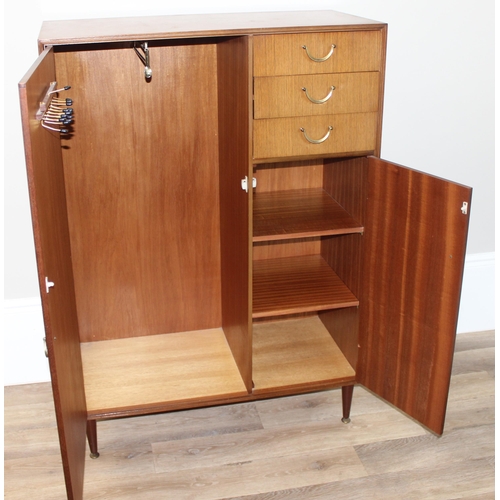 65 - A retro Meredew gentleman's wardrobe with 3 short drawers, one containing a fold out mirror, approx ... 