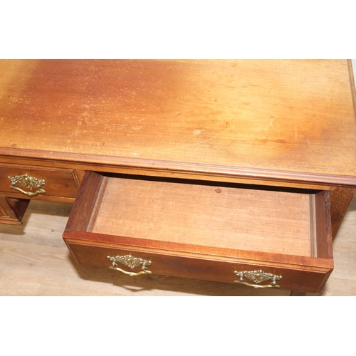 140 - A vintage mahogany desk with 4 drawers, approx 115cm wide x 55cm deep x 78cm tall