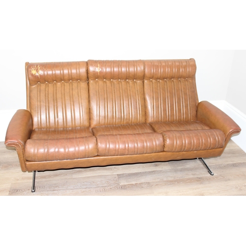 57 - In the manner of Karl Wittmann, a retro brown leather effect sofa with chrome legs, seemingly unmark... 