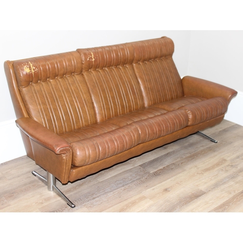 57 - In the manner of Karl Wittmann, a retro brown leather effect sofa with chrome legs, seemingly unmark... 