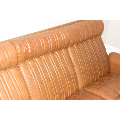 57 - In the manner of Karl Wittmann, a retro brown leather effect sofa with chrome legs, seemingly unmark... 