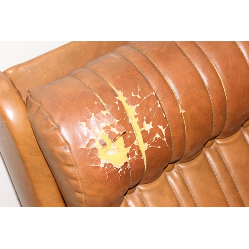 57 - In the manner of Karl Wittmann, a retro brown leather effect sofa with chrome legs, seemingly unmark... 