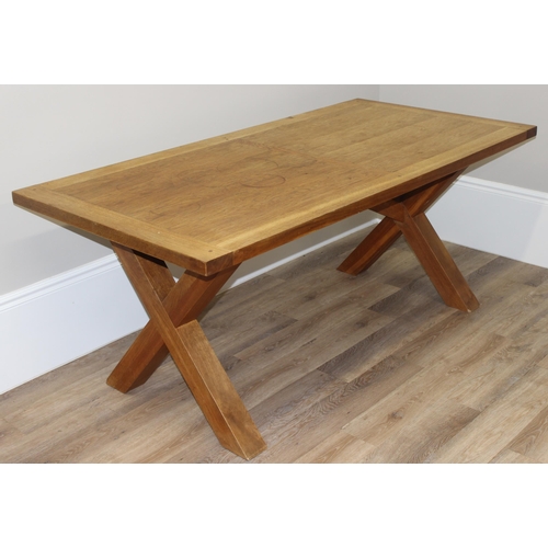 35 - A very heavy light oak dining table with X frame base, approx 180cm wide x 90cm deep x 75cm tall