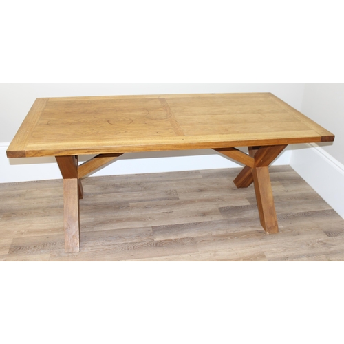 35 - A very heavy light oak dining table with X frame base, approx 180cm wide x 90cm deep x 75cm tall