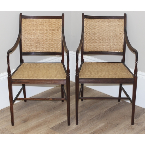 181 - A pair of George III style Anglo Indian armchairs with finely turned ebonised frame and tightly work... 