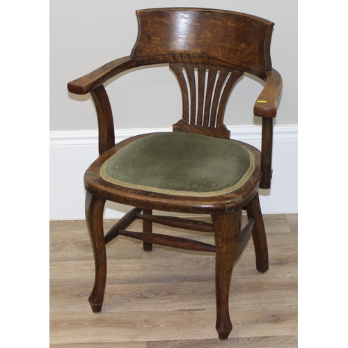 100 - An early 20th century oak desk chair with green fabric seat, approx 84cm tall