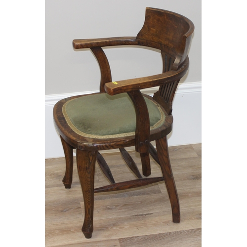 100 - An early 20th century oak desk chair with green fabric seat, approx 84cm tall