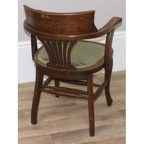 100 - An early 20th century oak desk chair with green fabric seat, approx 84cm tall