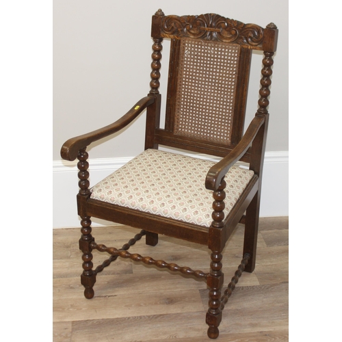 26 - A Carolean style oak armchair with bobbin turned supports and bergere back, approx 91cm tall